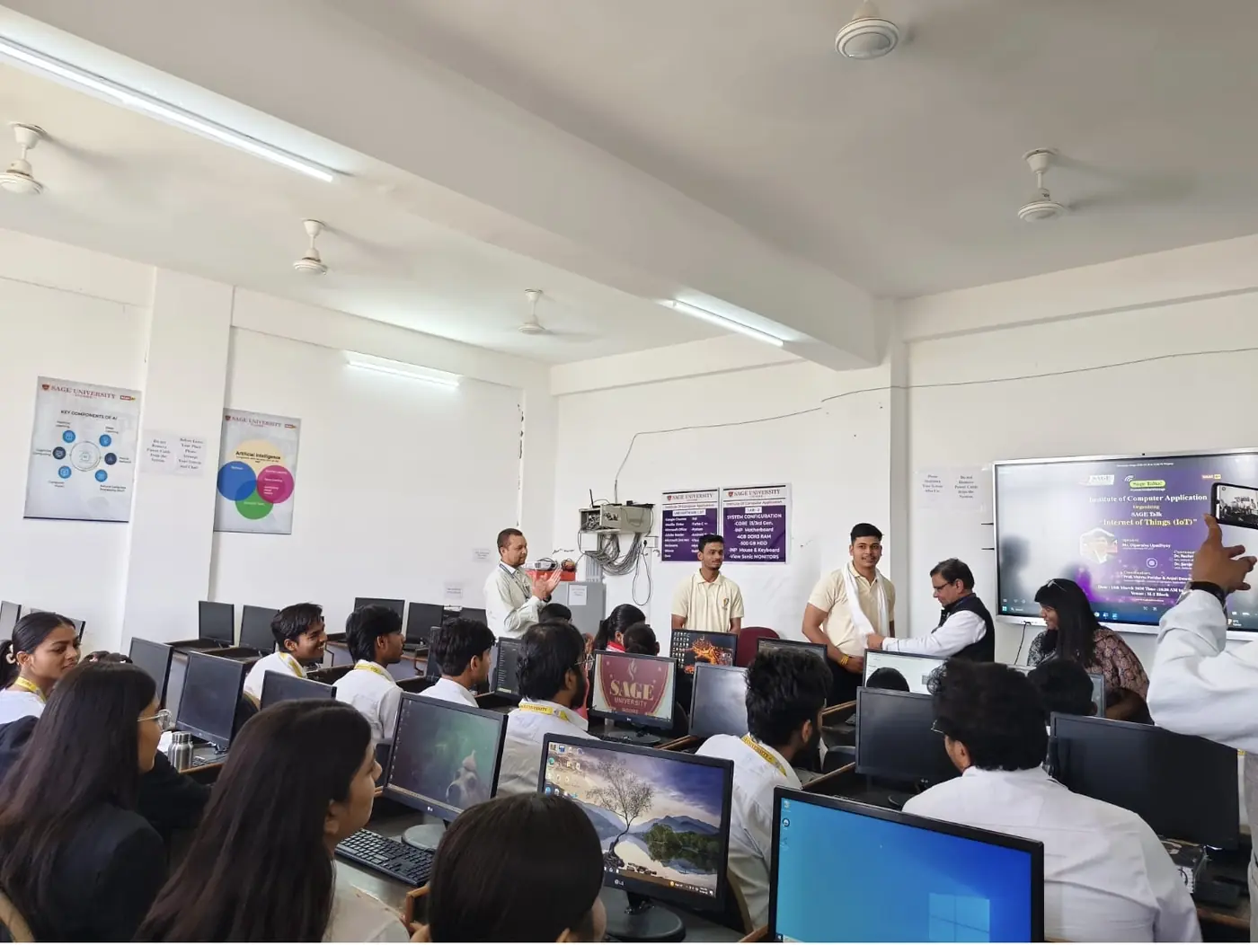 Students and faculty at computers during a session in a college lab