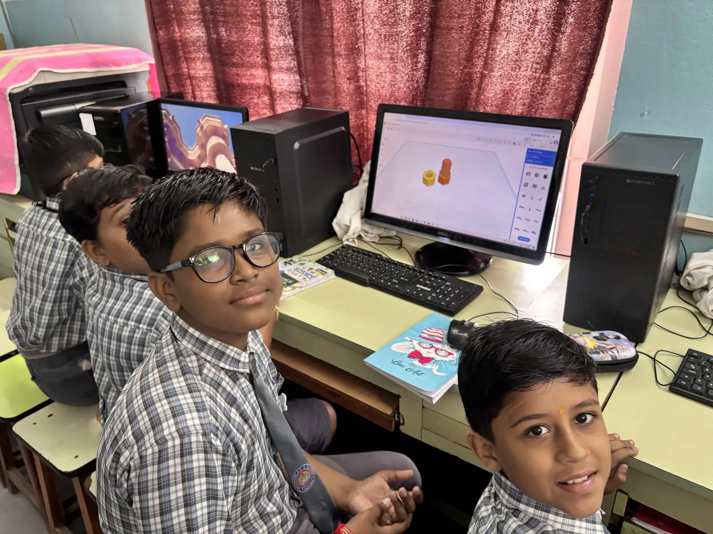 School students at a computer lab working on 3D design software