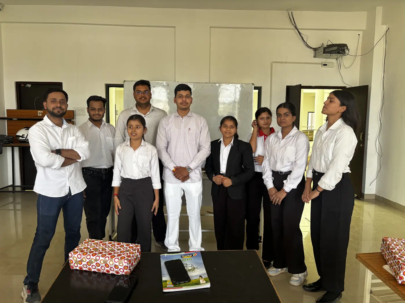 A group photo of the team in a classroom after a session