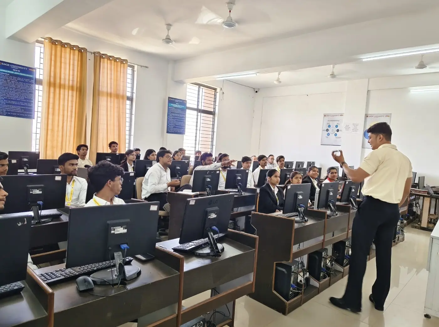 A university computer lab session with students at their workstations